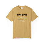 A mustard crewneck t-shirt with a humorous 'CAT DAD' graphic on the chest featuring a loading bar and the text 'loading.
