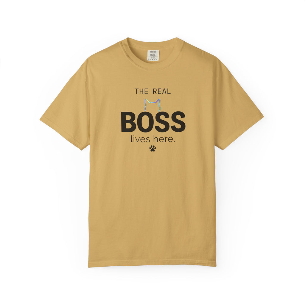 A tan crewneck t-shirt with a graphic print on the front that reads 'THE REAL BOSS lives here.' with a small cat silhouette and paw print, displayed on a clean white background.
