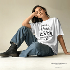 Woman wearing a white t-shirt with text sitting on the floor.