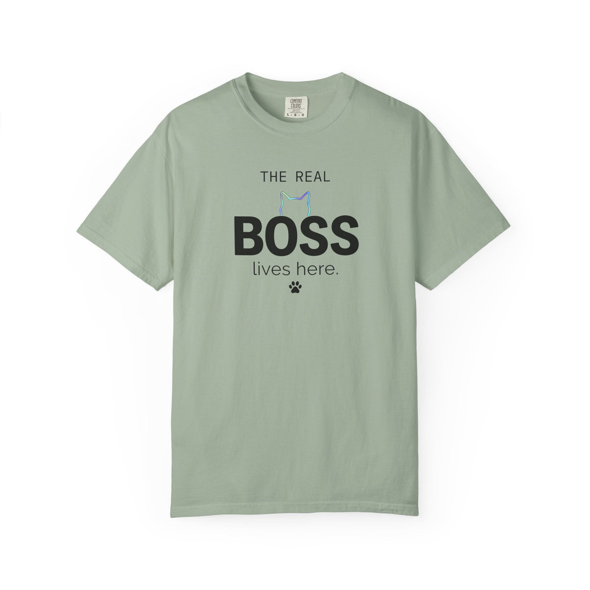 A sage green short-sleeve t-shirt with black Arabic calligraphy printed on the chest, displayed flat against a plain white background.