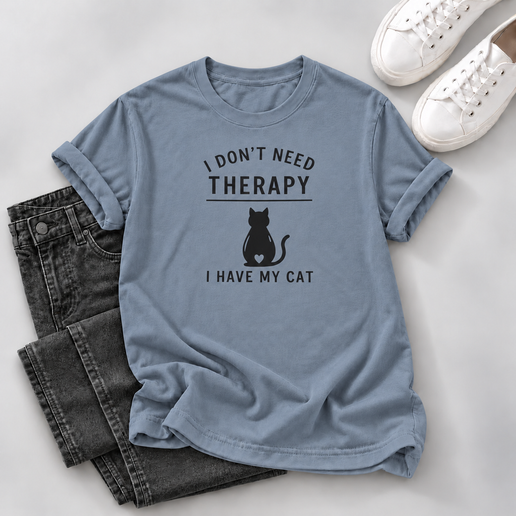 Blue-gray T-shirt with black “I Don’t Need Therapy I Have My Cat” lettering and a seated cat silhouette with a heart cutout, on a white background.