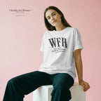 Woman wearing a white t-shirt with 'WFH just need Cats & Coffee' text on a pink background