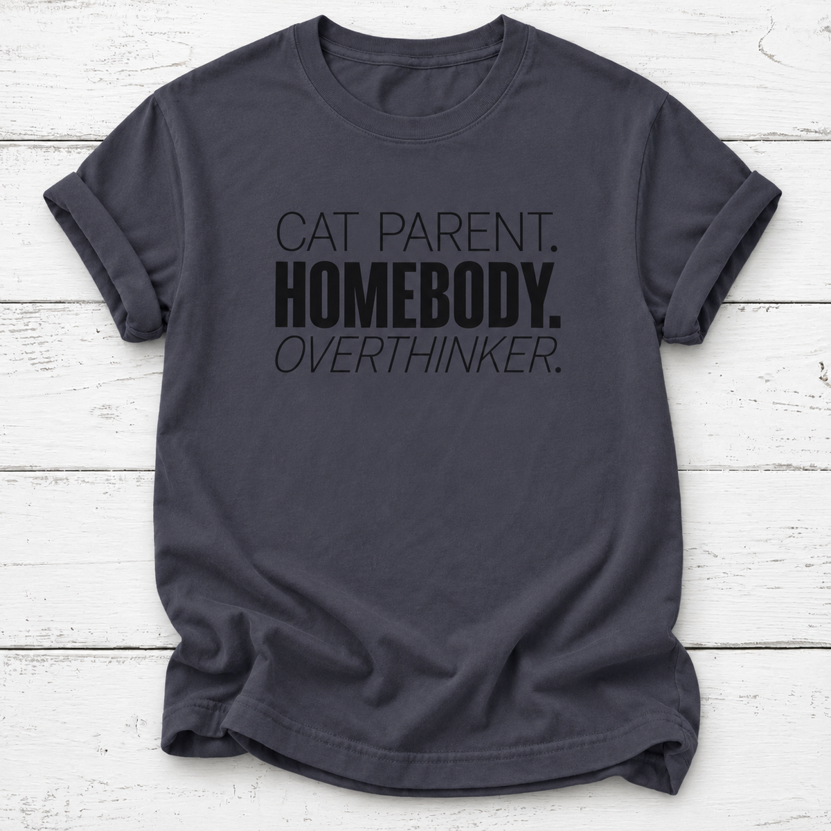 A navy gray t-shirt with black printed text reading 'CAT PARENT. HOMEBODY.