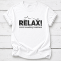 A white short-sleeve crewneck t-shirt with a black graphic print on the front. The graphic features the word 'RELAX!' in bold capital letters with a minimalist line drawing of a cat above it, and the phrase 'micro kneading treatment' printed below in a smaller font.